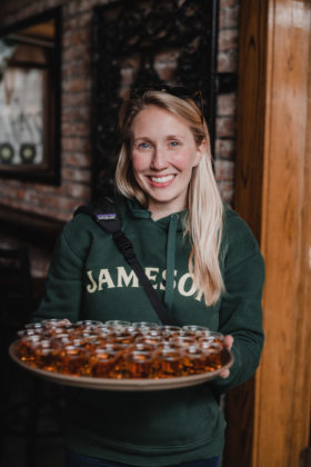 A woman hands out shots